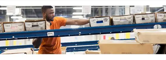 Man sorting packages in a warehouse