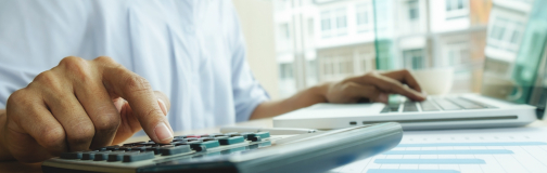 Man using adding machine