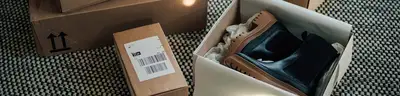 Multiple packages & a pair of ankle boots in open box