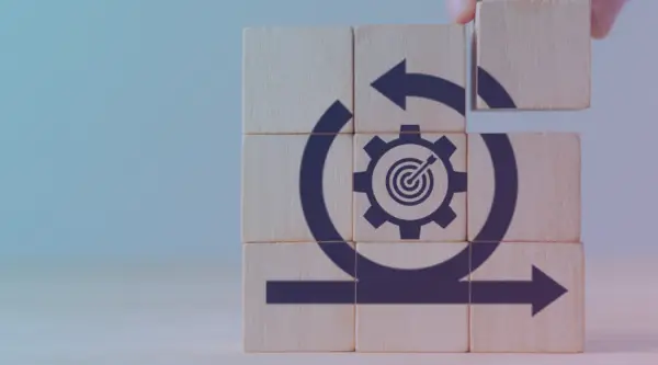 a hand preventing additional dominos from being knocked over